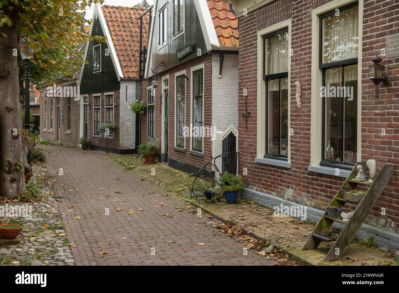 Idyllic narrow houses on the church square in Oosterend on Texel Stock ...