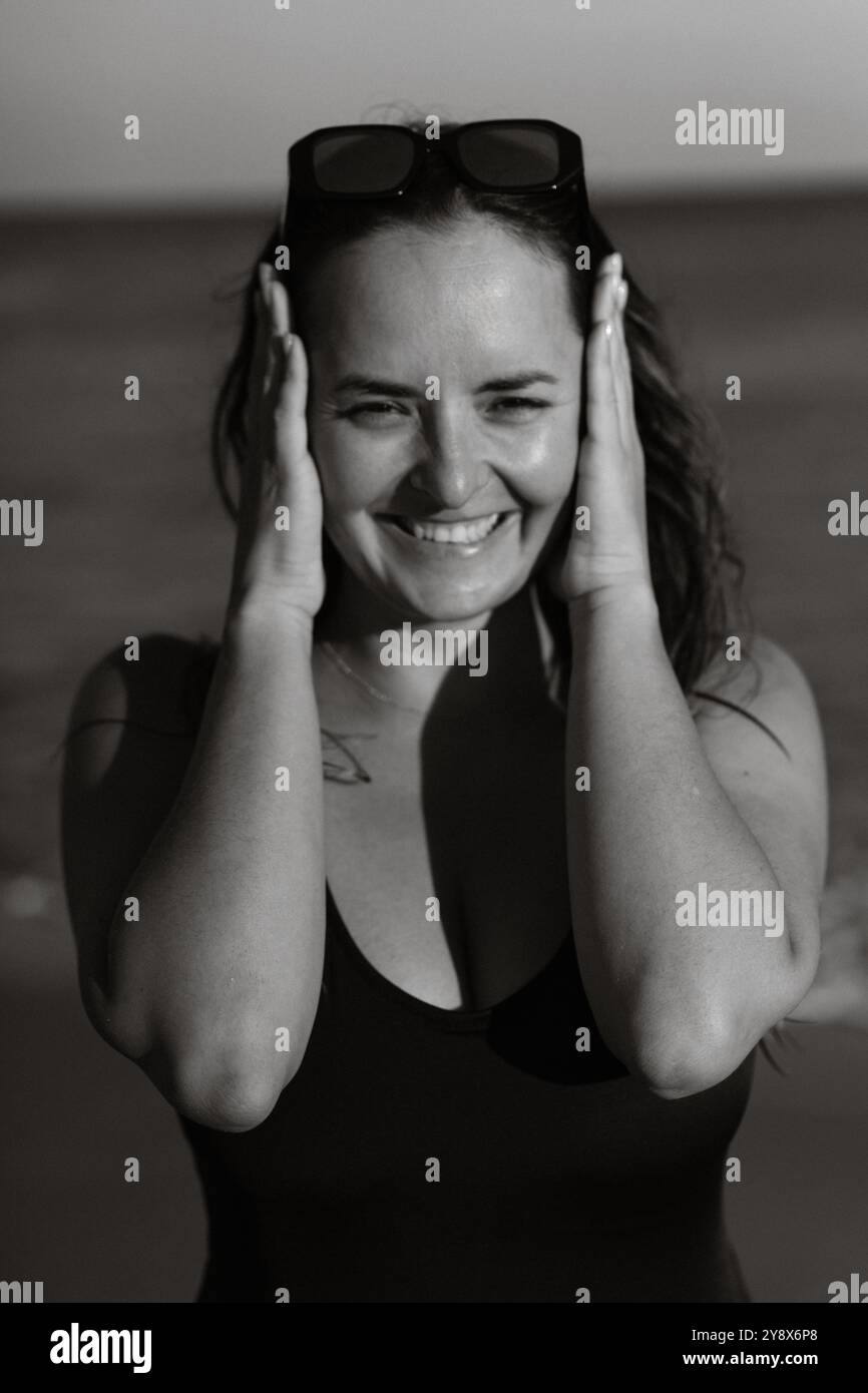 Portrait of smiling young woman on the beach Stock Photo - Alamy