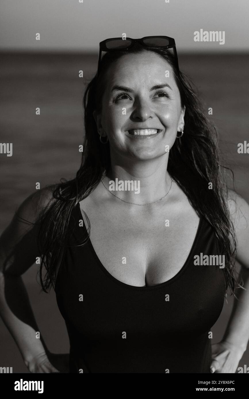 Portrait of smiling young woman on the beach Stock Photo - Alamy