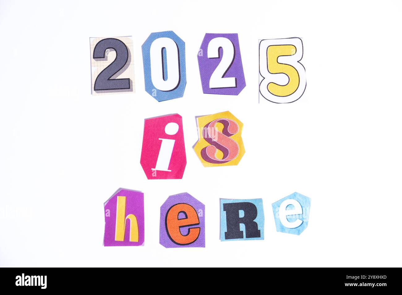 Phrase 2025 is here, spelled in cut out newspaper style typography, isolated on white background. Stock Photo