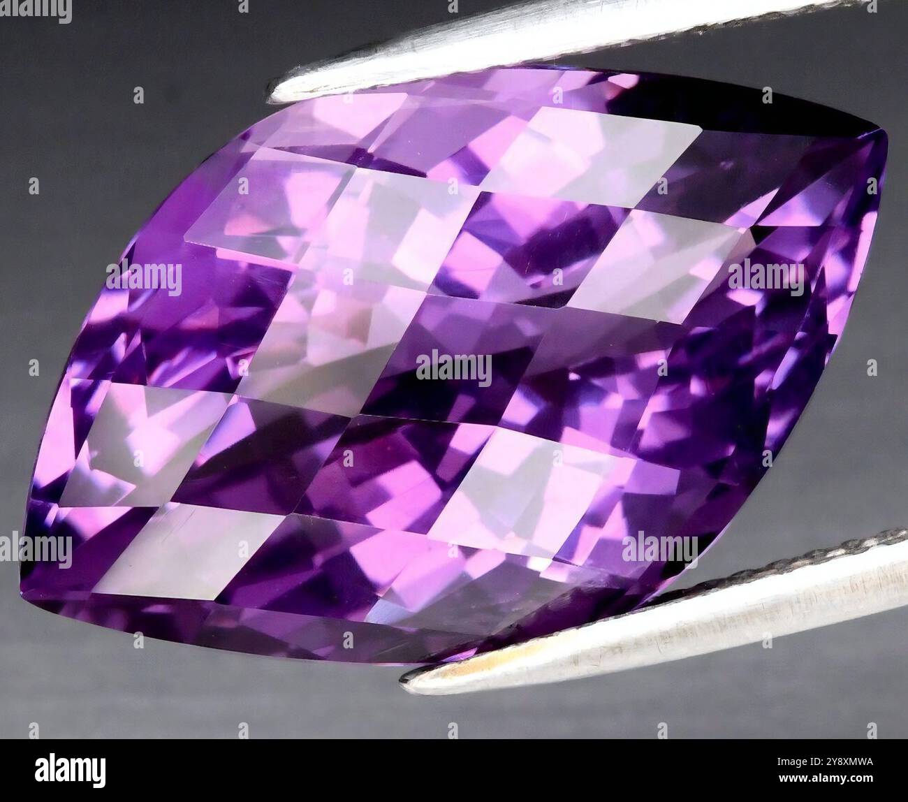 A Dazzling Large Purple Amethyst Gemstone Reflecting Light Elegantly. Stock Photo