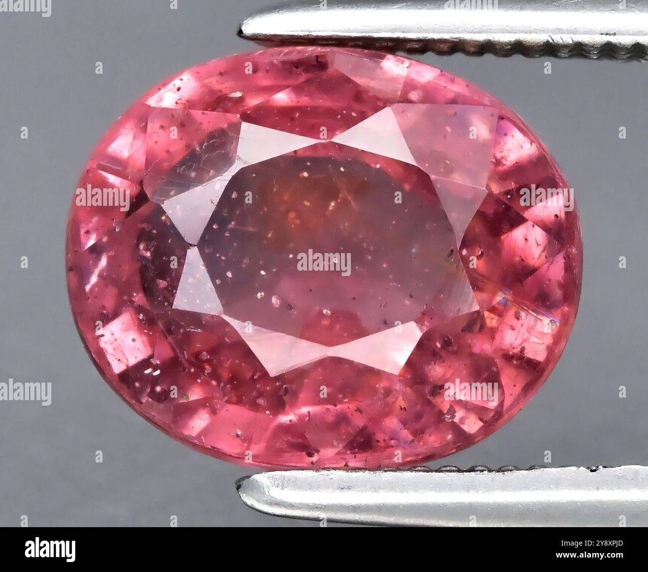 Exquisite Oval-Cut Pink Tourmaline with Intriguing Inclusions and Radiant Luster. Stock Photo