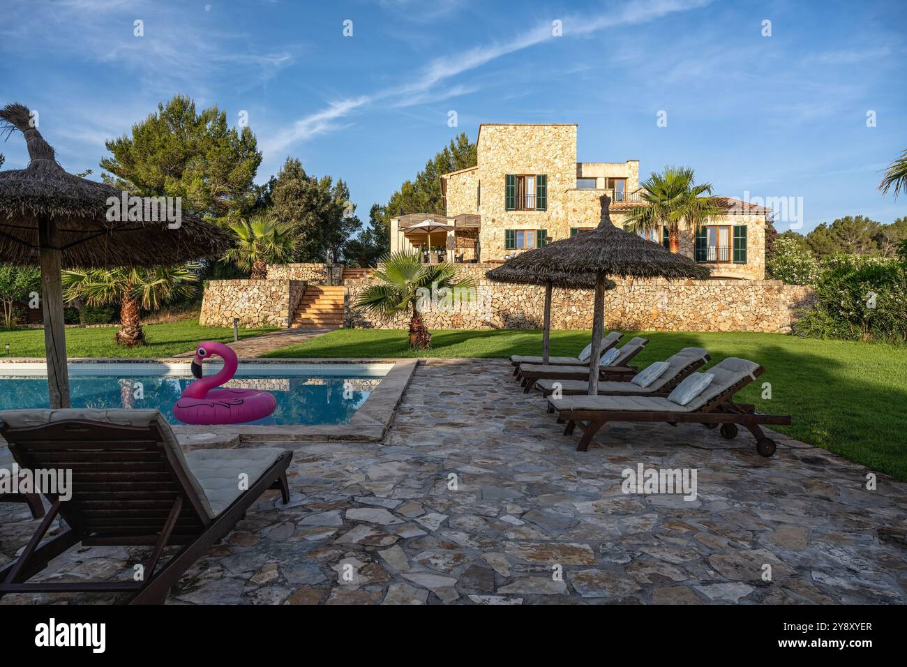 Shaded sunloungers at poolside of luxury Spanish villa, Mallorca. Stock Photo