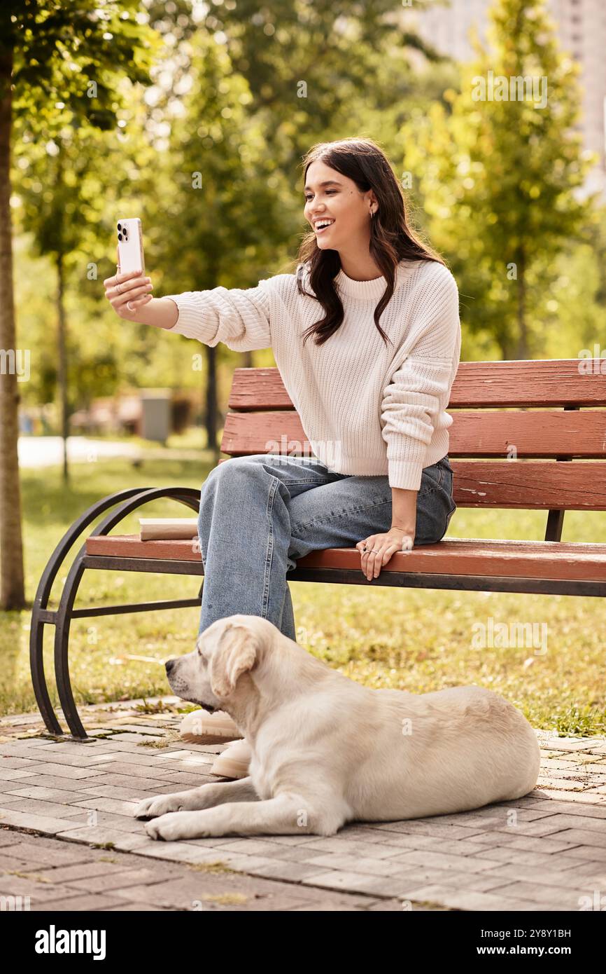 A cheerful woman enjoys a delightful moment, capturing a selfie with ...