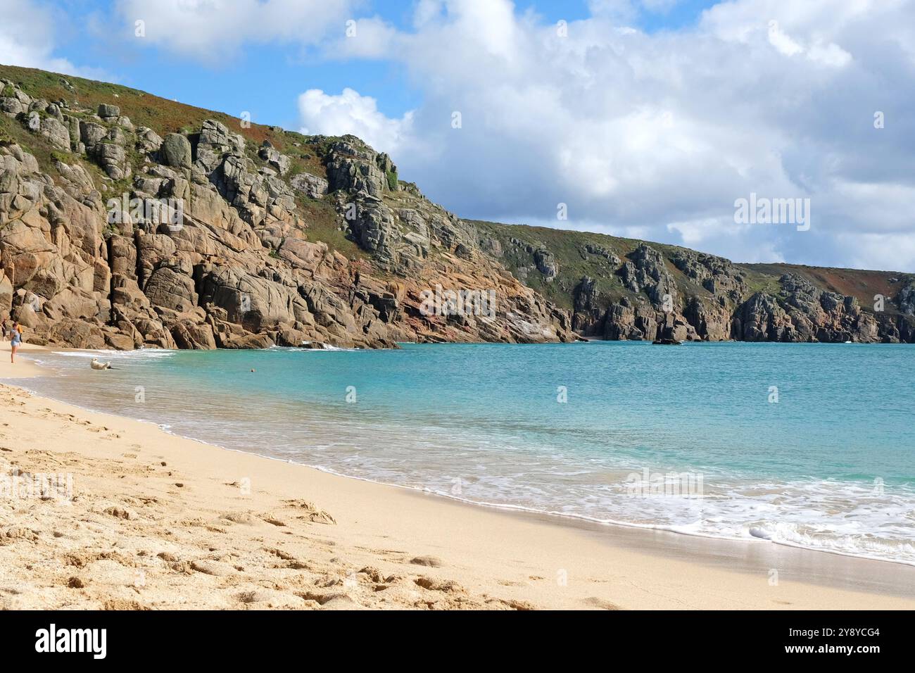 Sandy Porthcurno Beach, with Logan Rock headland, West Cornwall, UK. Stock Photo