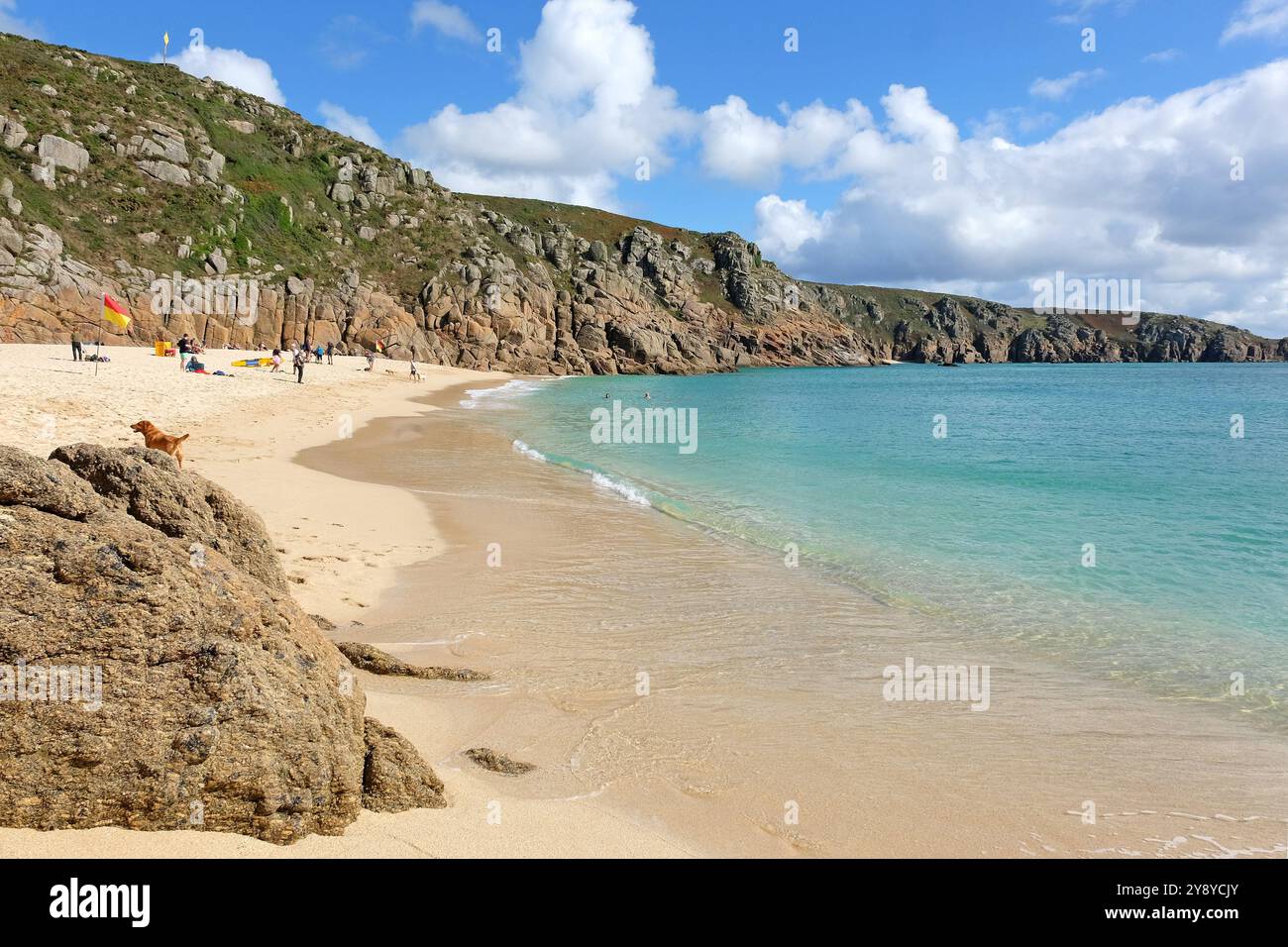 Sandy Porthcurno Beach, with Logan Rock headland, West Cornwall, UK. Stock Photo