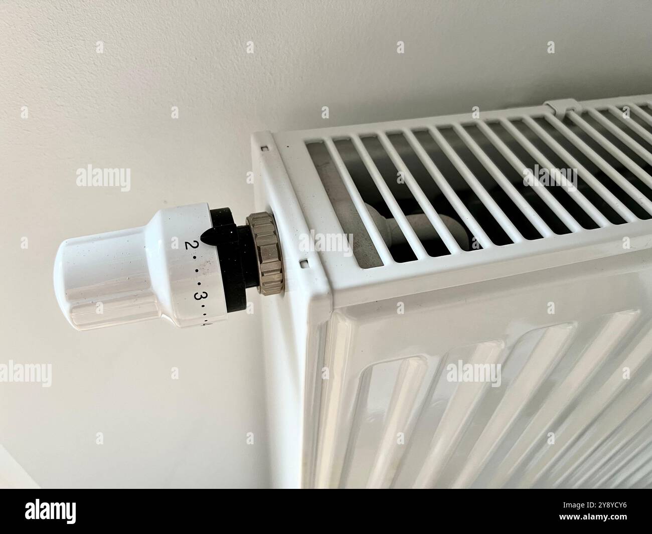 Close-up of a modern radiator and adjustable valve. The image highlights the clean design and metallic texture, perfect for illustrating home heating, - Smartphone Captured Stock Image