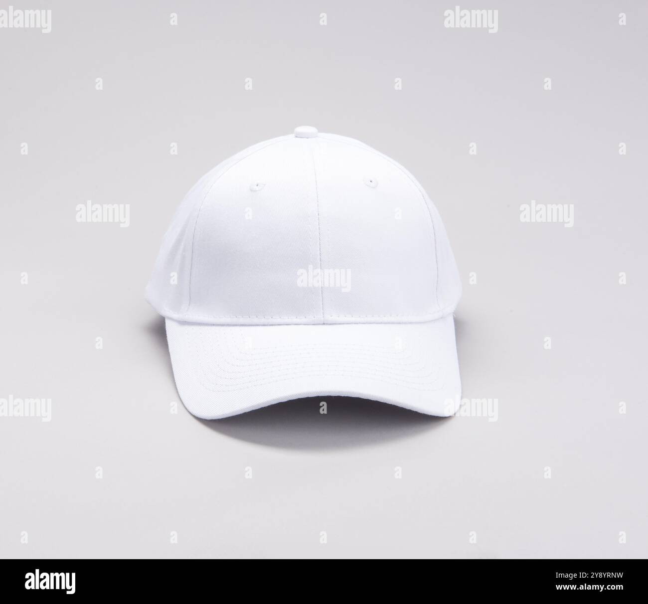 Front view of White Baseball cap on grey background Stock Photo