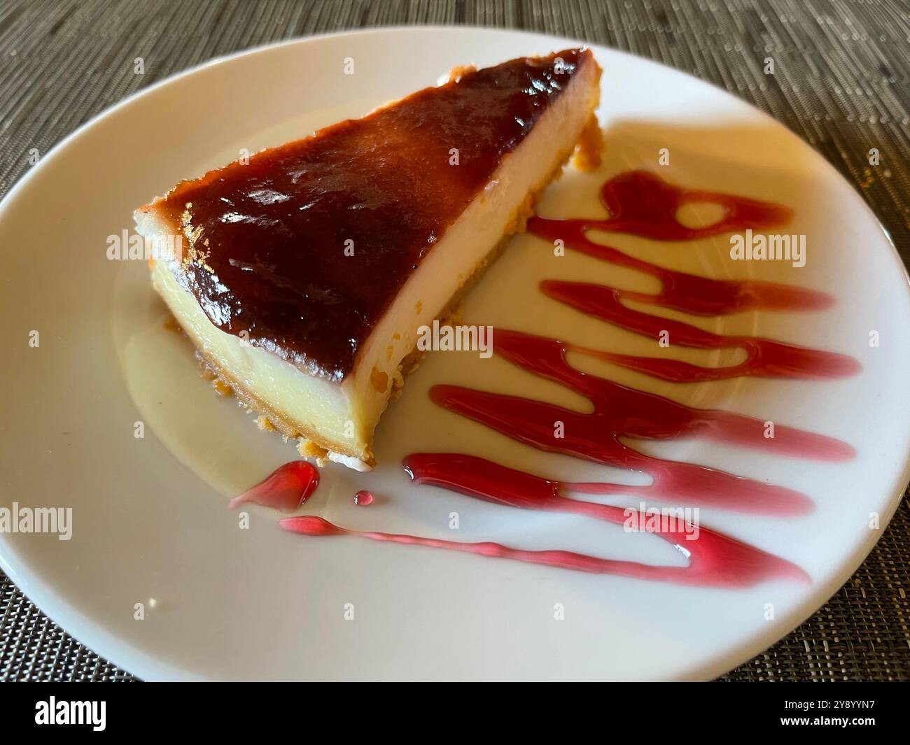 Cheese cake with strawberry syrup. Stock Photo