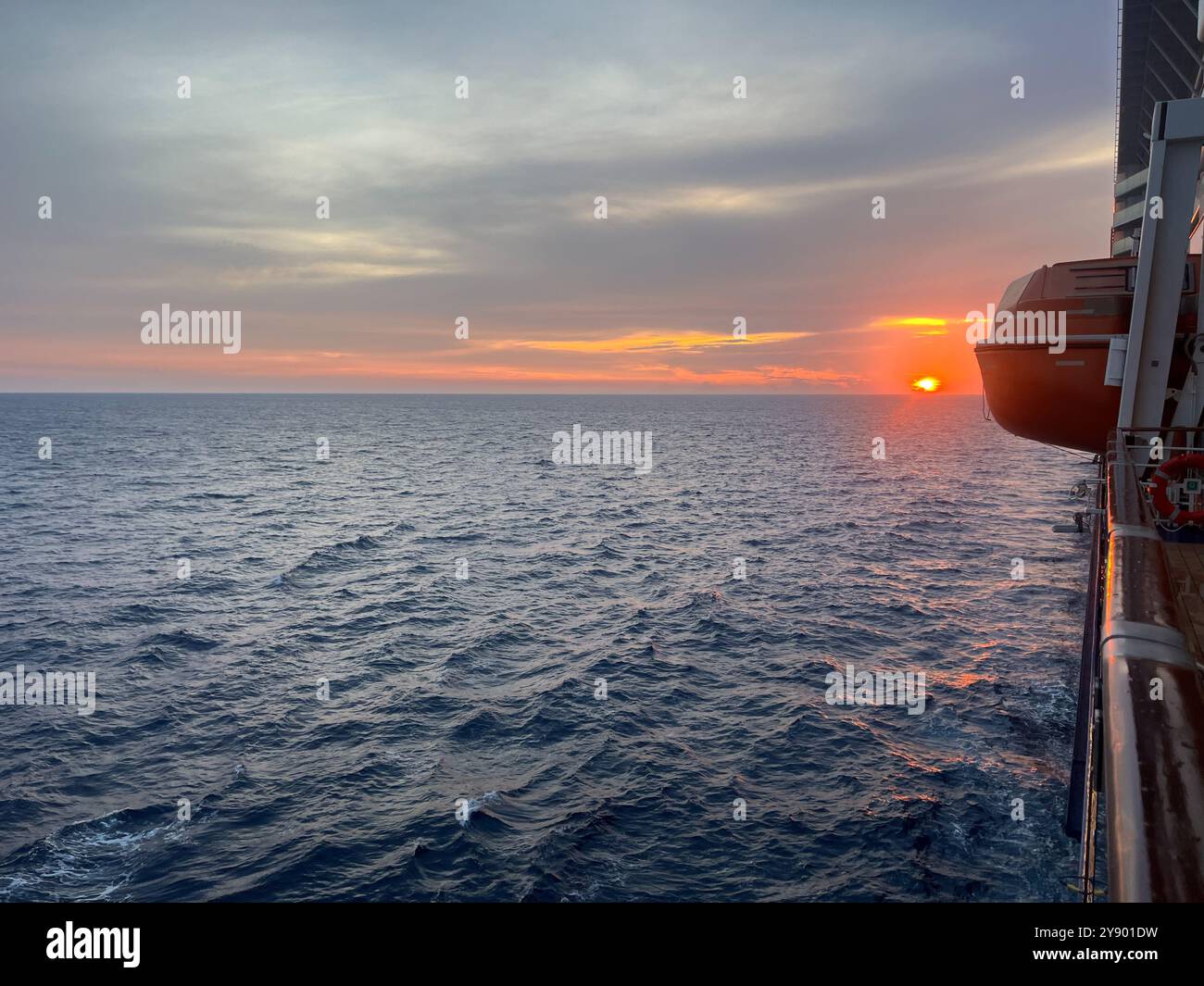 Golden hues on the horizon of the Atlantic Ocean, as seen from a cruise ship - Smartphone Captured Stock Image