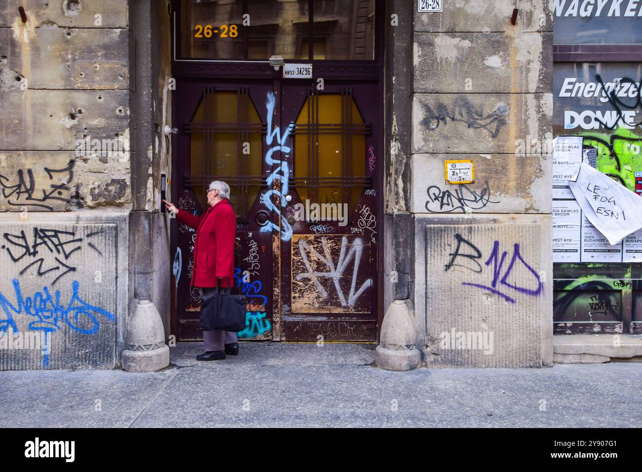 Woman calling on the intercom in Budapest Stock Photo