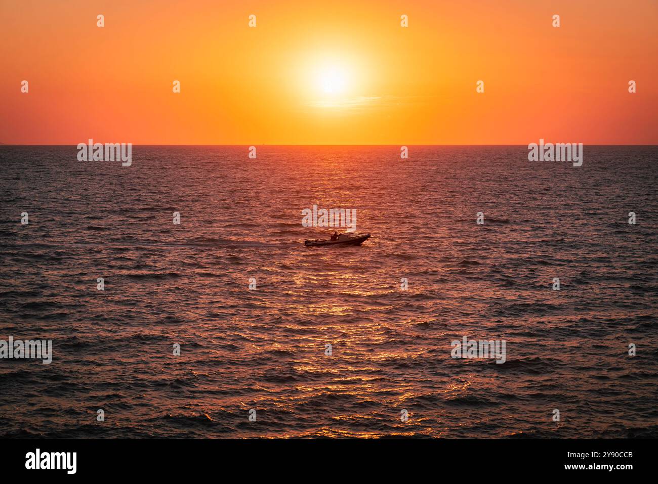 Sunset on the sea. And a boat. Stock Photo