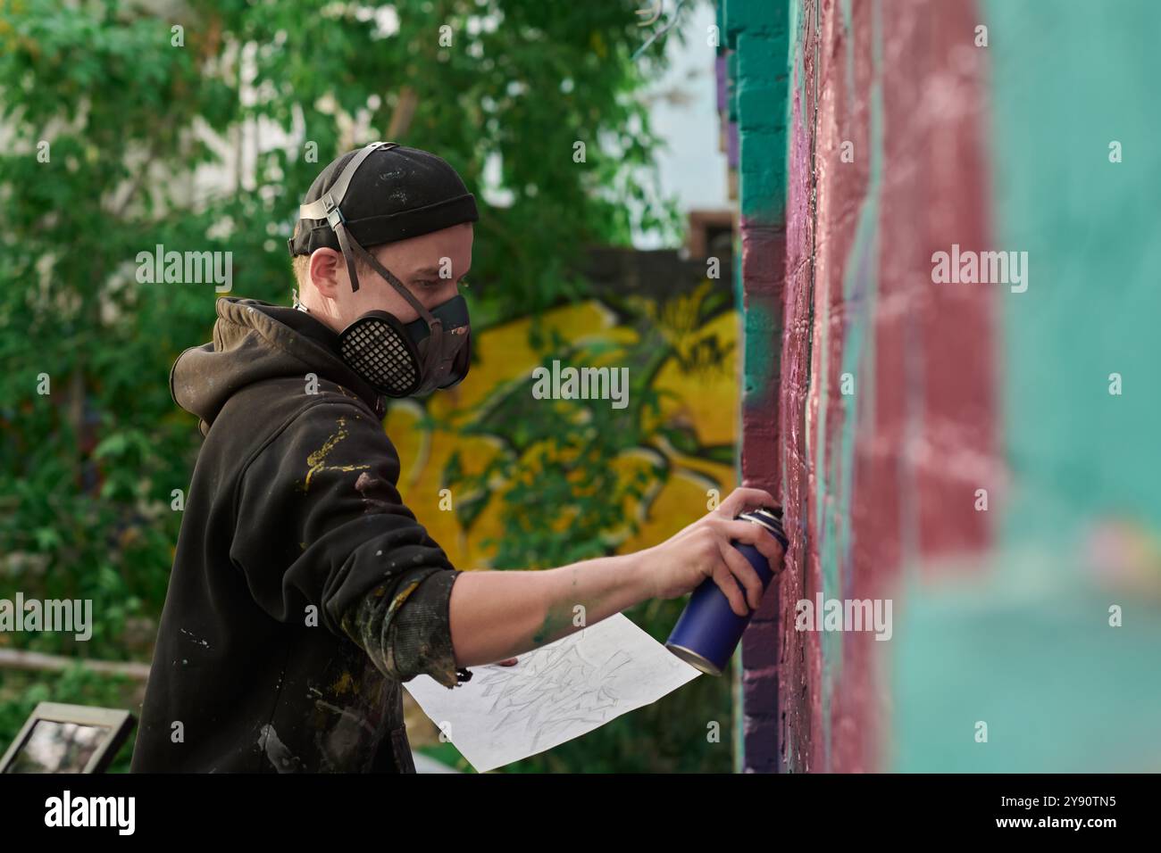 Male teen painting wall spray paint hi-res stock photography and images ...