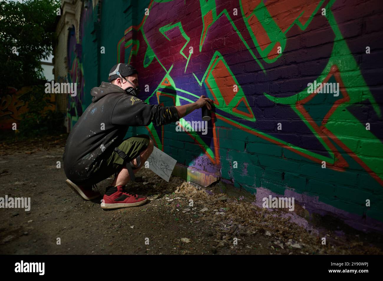 Man spray painting wall in the dark hi-res stock photography and images ...
