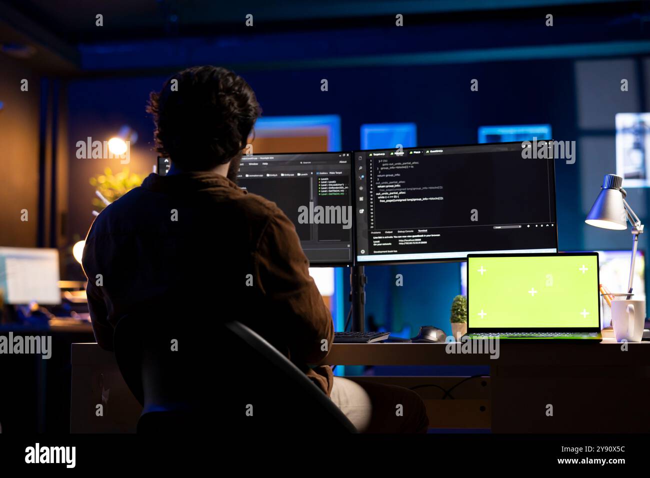 Programmer using green screen laptop to implement security measures, protecting company systems and data. IT worker writing, testing and debugging code for software applications on chroma key notebook Stock Photo