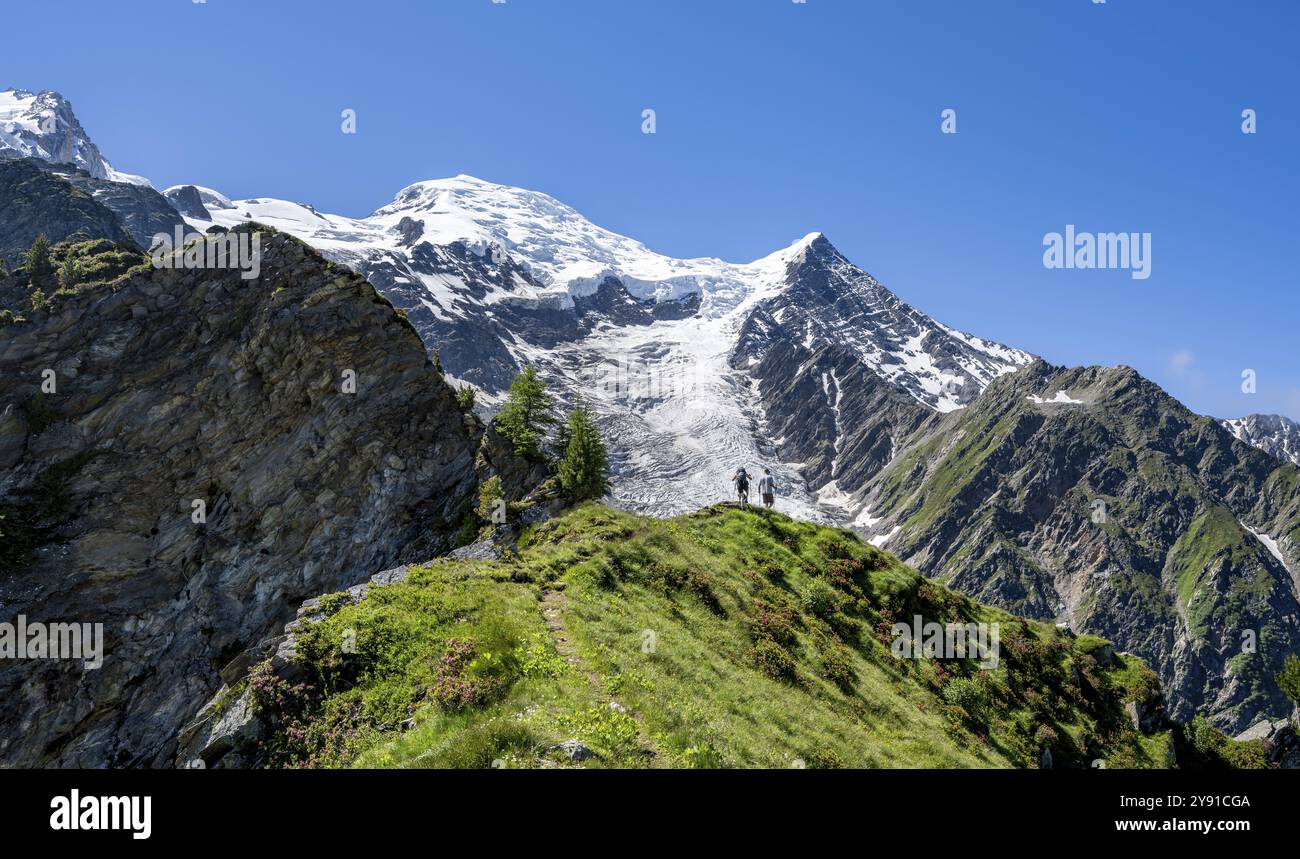 Mountaineer on a hiking trail in front of mountain landscape with glacier, view of glacier Glacier de Taconnaz, hike La Jonction, Chamonix, Haute-Savo Stock Photo