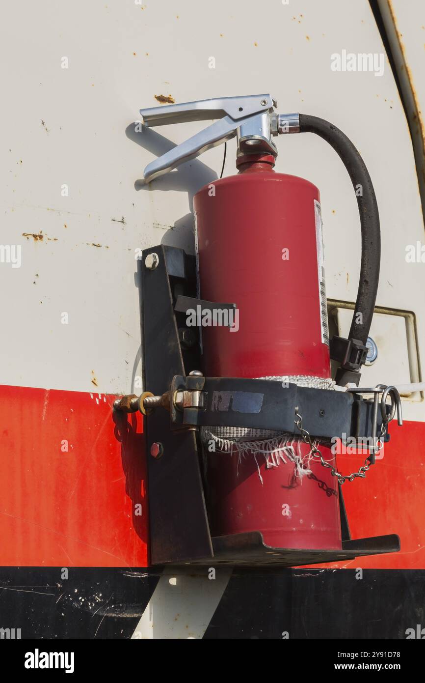 Close-up of fire extinguisher mounted on side of backhoe excavator, Quebec, Canada, North America Stock Photo