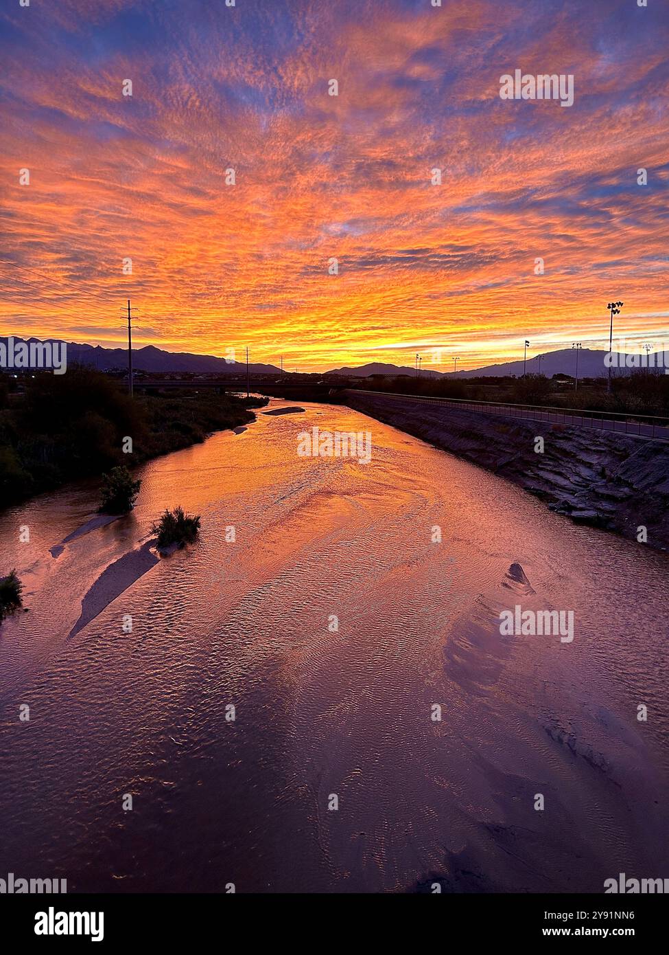 Sunrise colors the sky over the Rillito River, Sonoran Desert, Tucson, Arizona, USA. - Smartphone Captured Stock Image