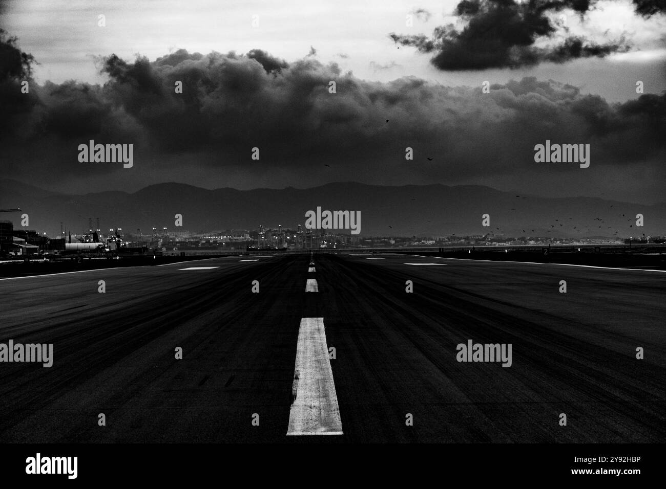 storm arriving on the landing strip in Gibraltar with a striking black and white Stock Photo