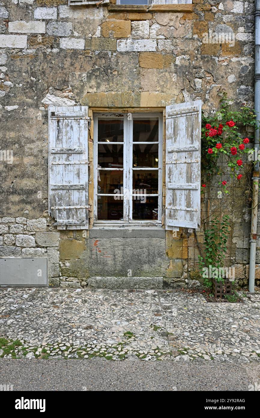Window of French house with white shutters with peeling and weathered ...