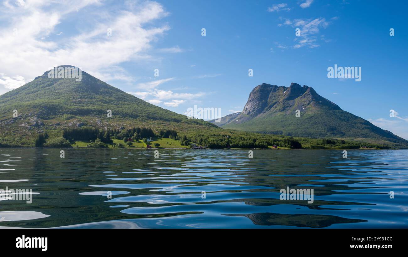 View of a fantasy place to live in Norway, a calm reflective sea in the foreground, image from Aldra an island just off the mainland coast, north of t Stock Photo