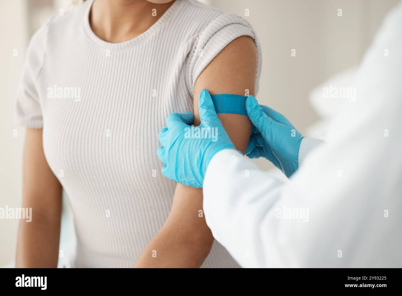 Hands, doctor and patient with plaster at clinic for vaccine injection ...