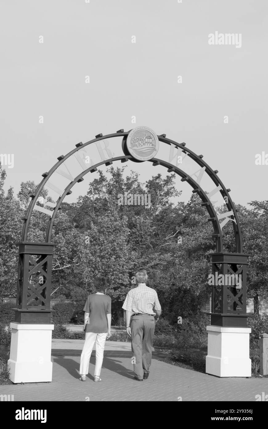 A Caucasian couple, 55 to 60 years, entering River Walk Park in the historic warehouse district of Conway, South Carolina, USA. Stock Photo