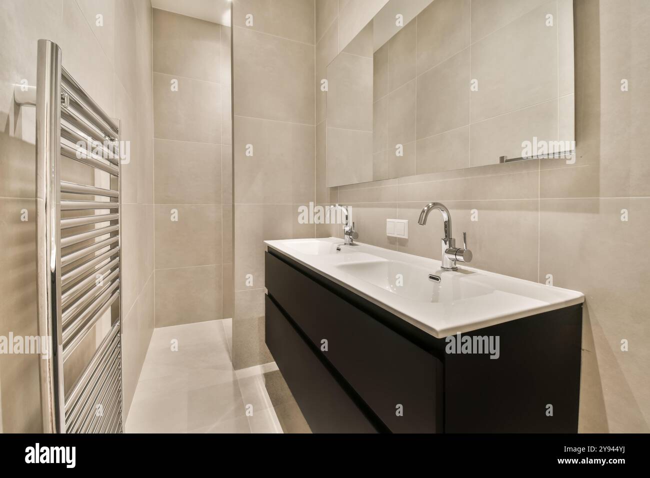 A sleek modern bathroom features a double sink vanity and a stainless ...