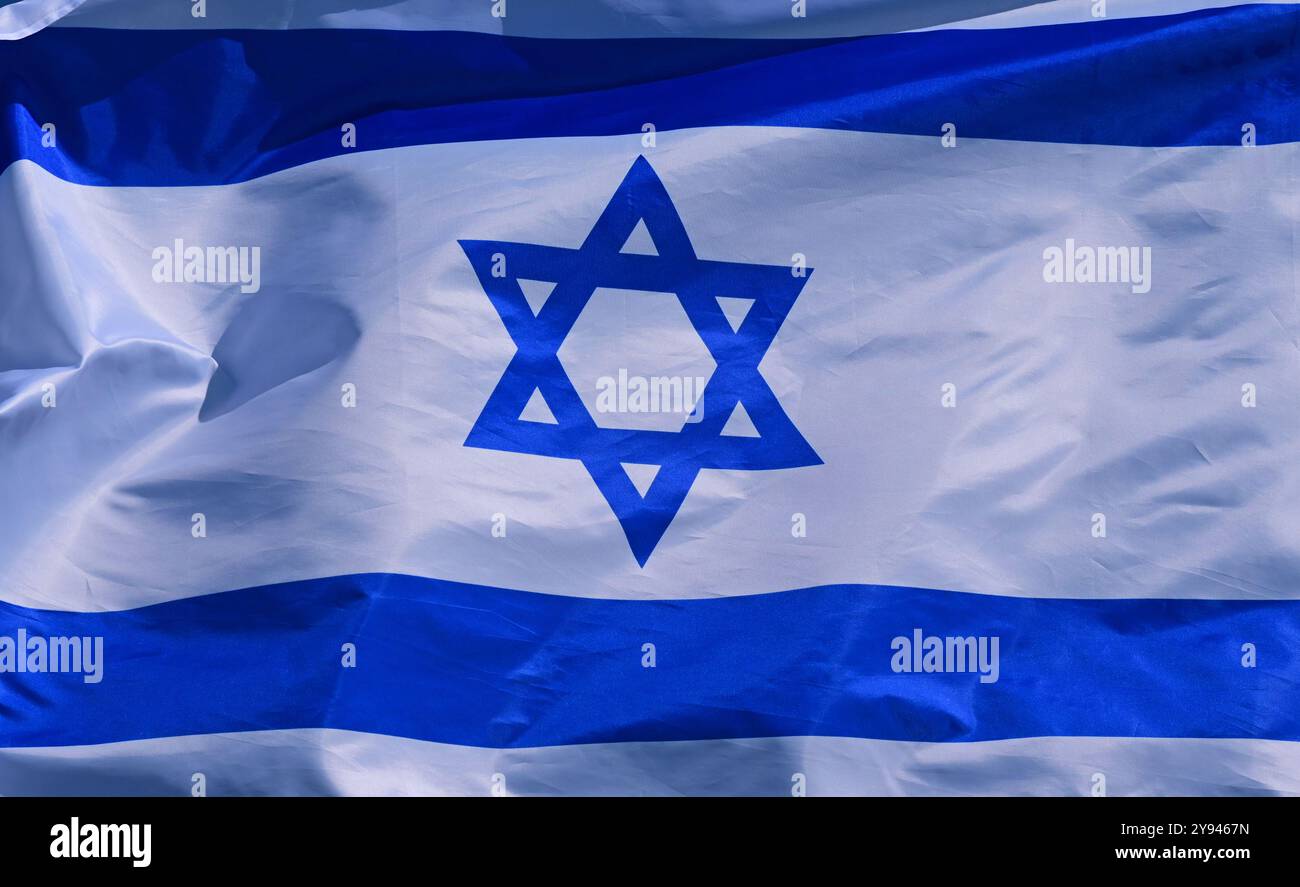 The flag of Israel flutters in the wind Stock Photo