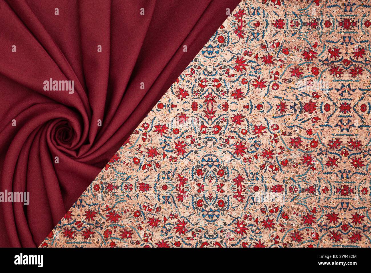 A detailed view of red fabric alongside a traditional Persian rug with floral patterns, showing rich textures and vibrant colors. Stock Photo