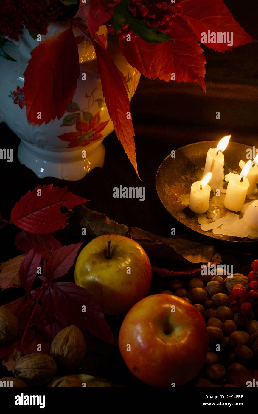 Still life of a vase with flowers, fruits and candles Stock Photo - Alamy