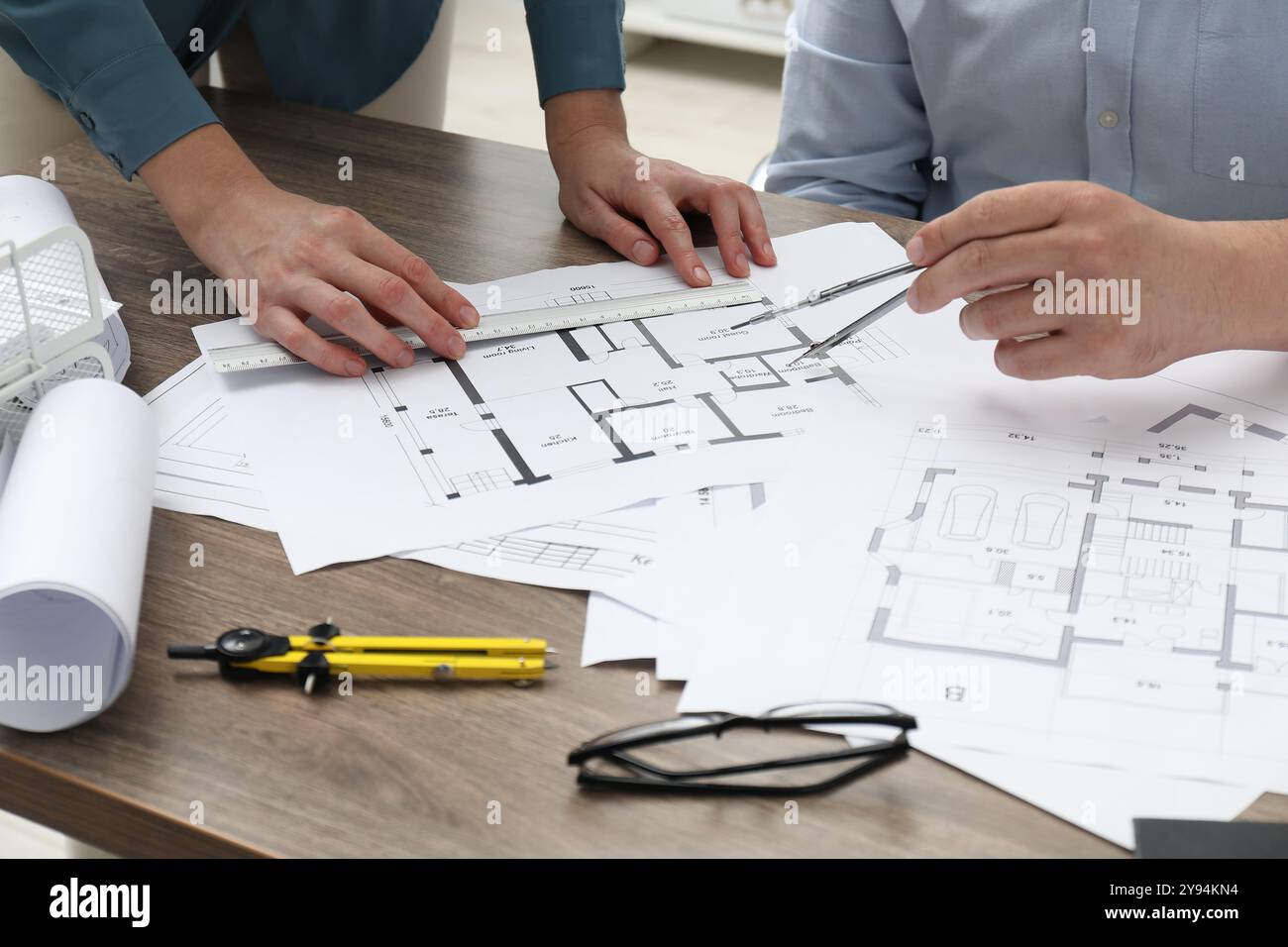 Architects working with project, closeup. Different technical drawings on wooden table Stock Photo
