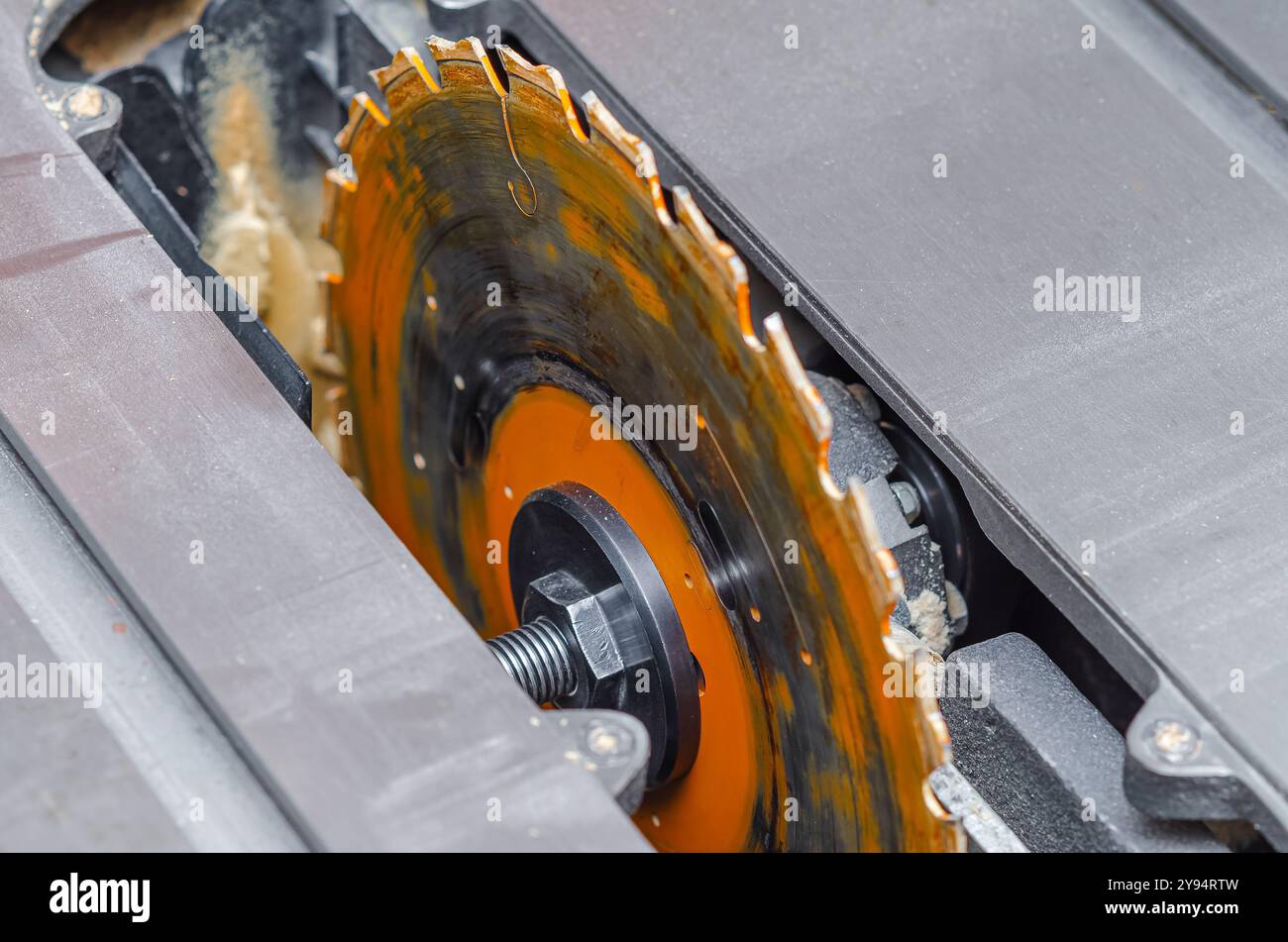 carpenter replaces a circular saw in a machine tool. Replacing the saw ...