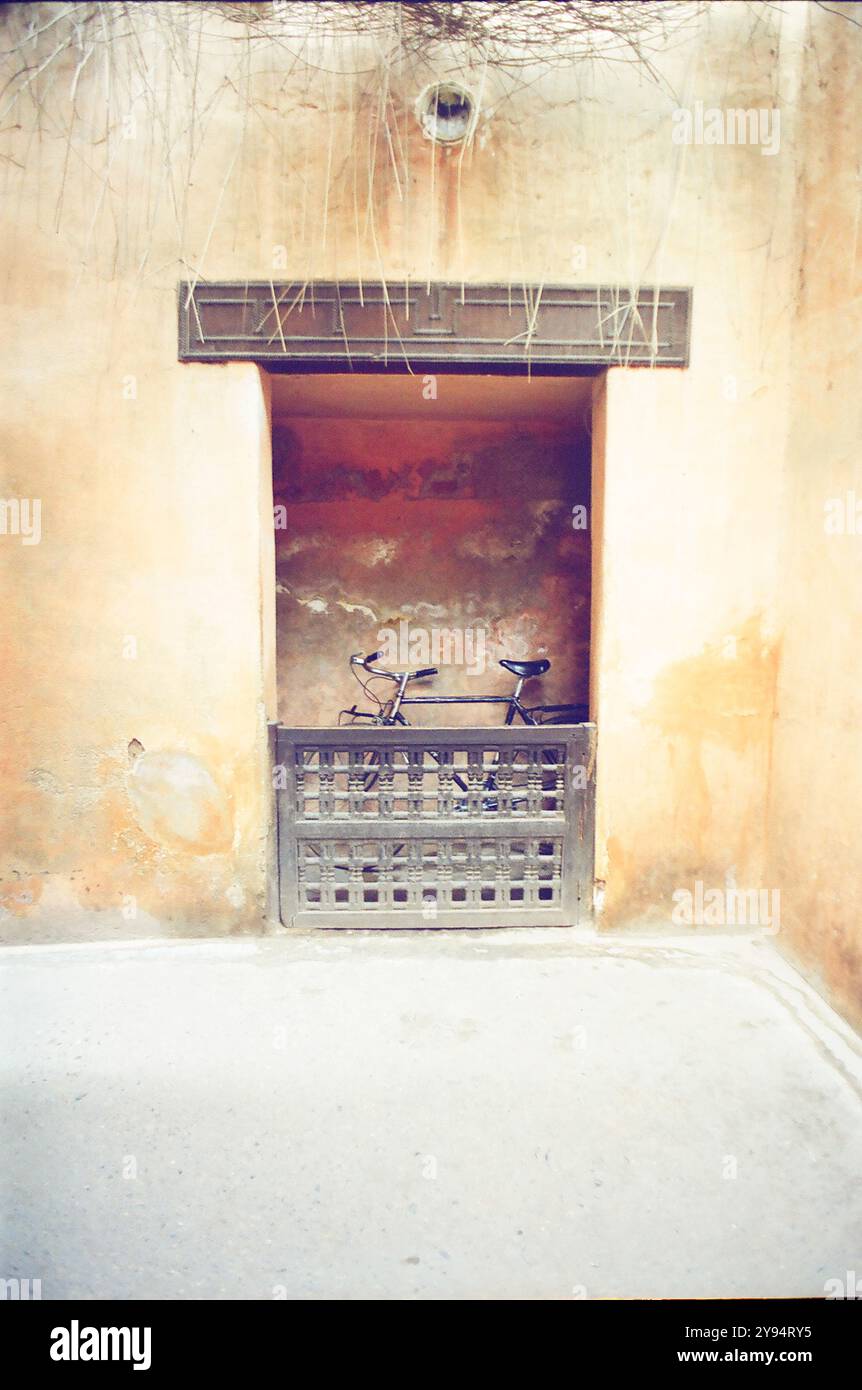 old bike parked inside a door in Marrakech in Morocco Stock Photo