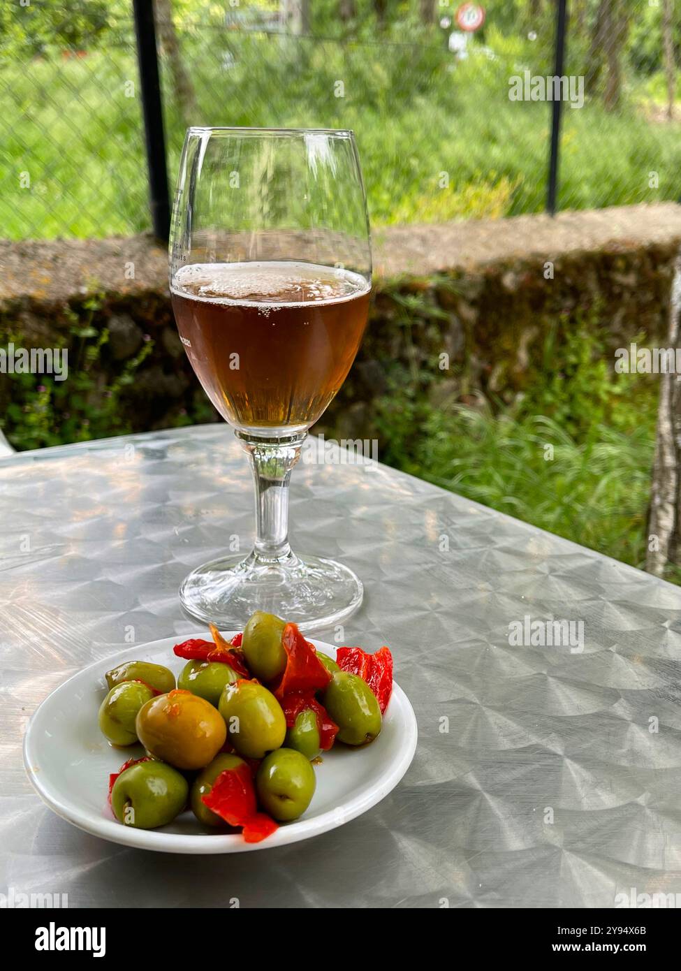 Glass of beer with tapa of green olives. Spain. - Smartphone Captured Stock Image