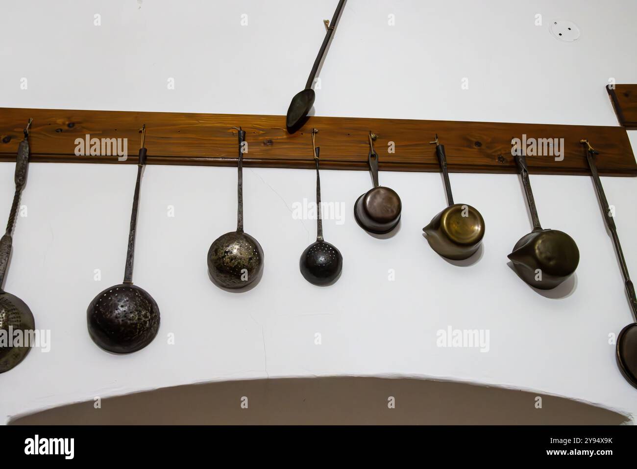 Old pots hanging on a wall at the Pharmacy Museum in Sibiu, Romania Stock Photo