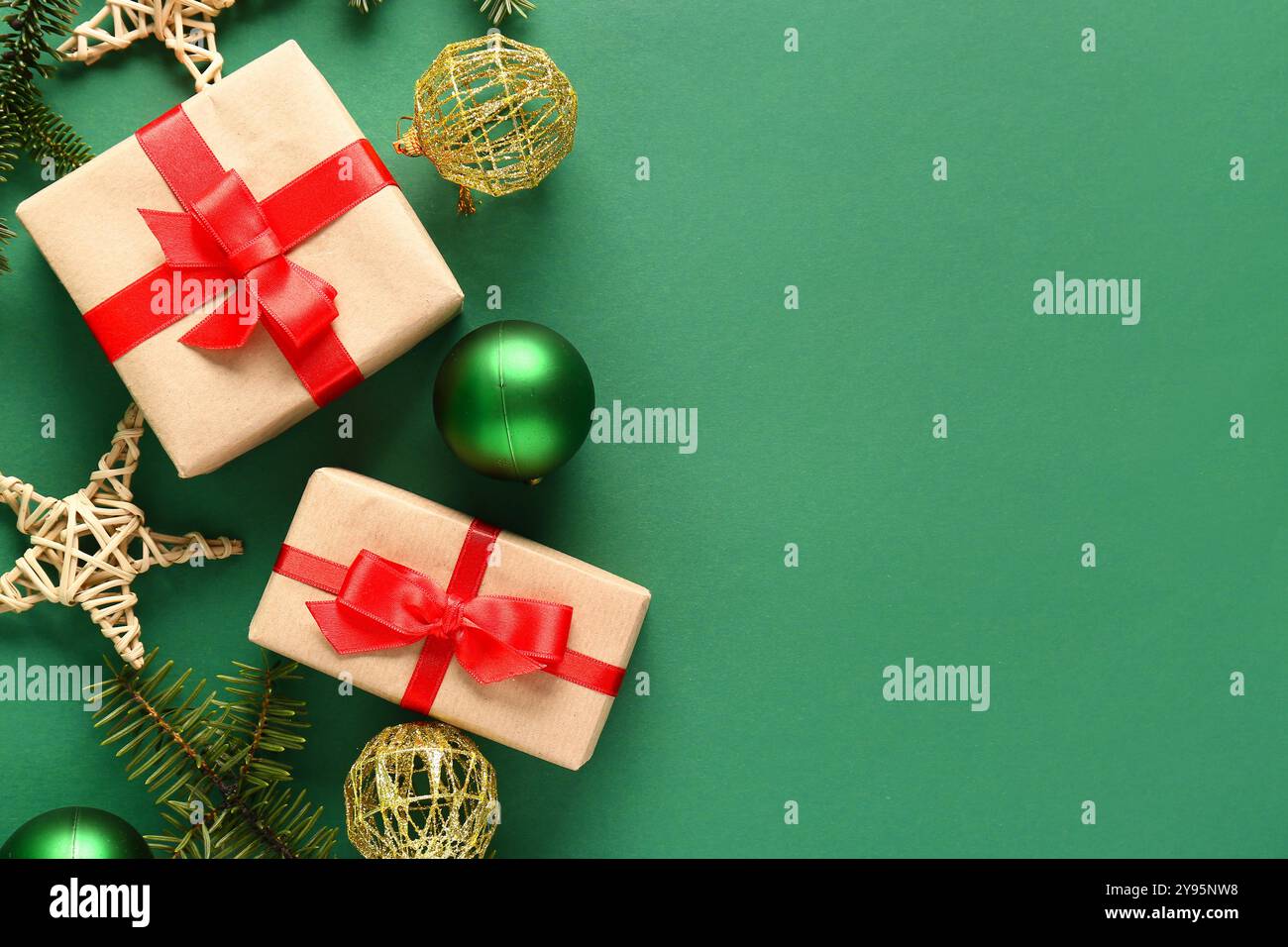Christmas gift boxes with fir branches and balls on green background ...