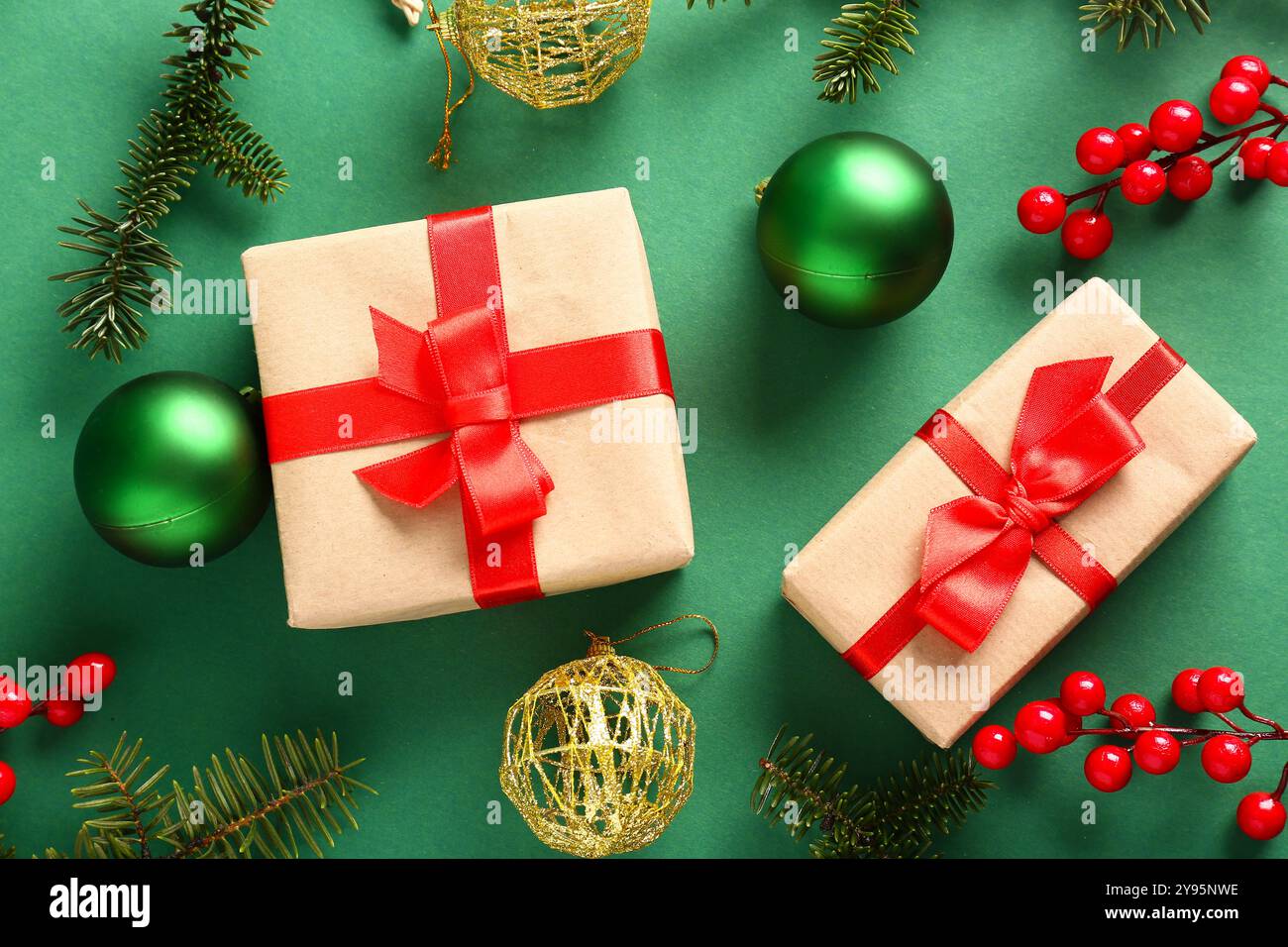 Christmas gift boxes with fir branches, balls and viburnum on green ...