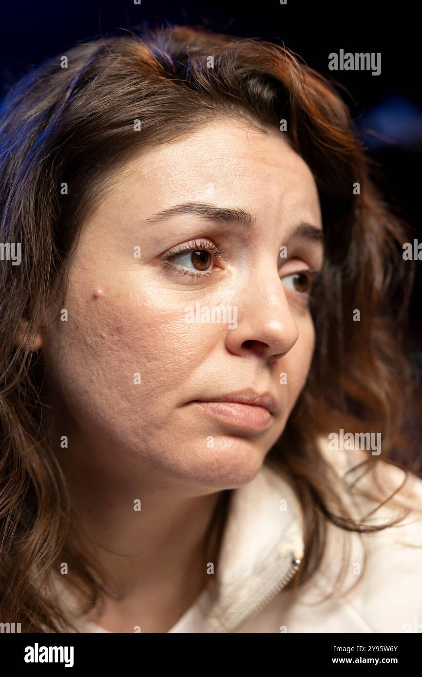 Troubled woman doing software quality assurance, finding major errors in source code. Depressed developer upset after inspecting coding on desktop PC and seeing many issues Stock Photo