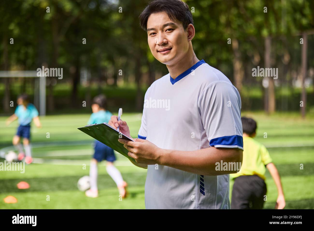 Coach and Kids in Football Training Class Stock Photo