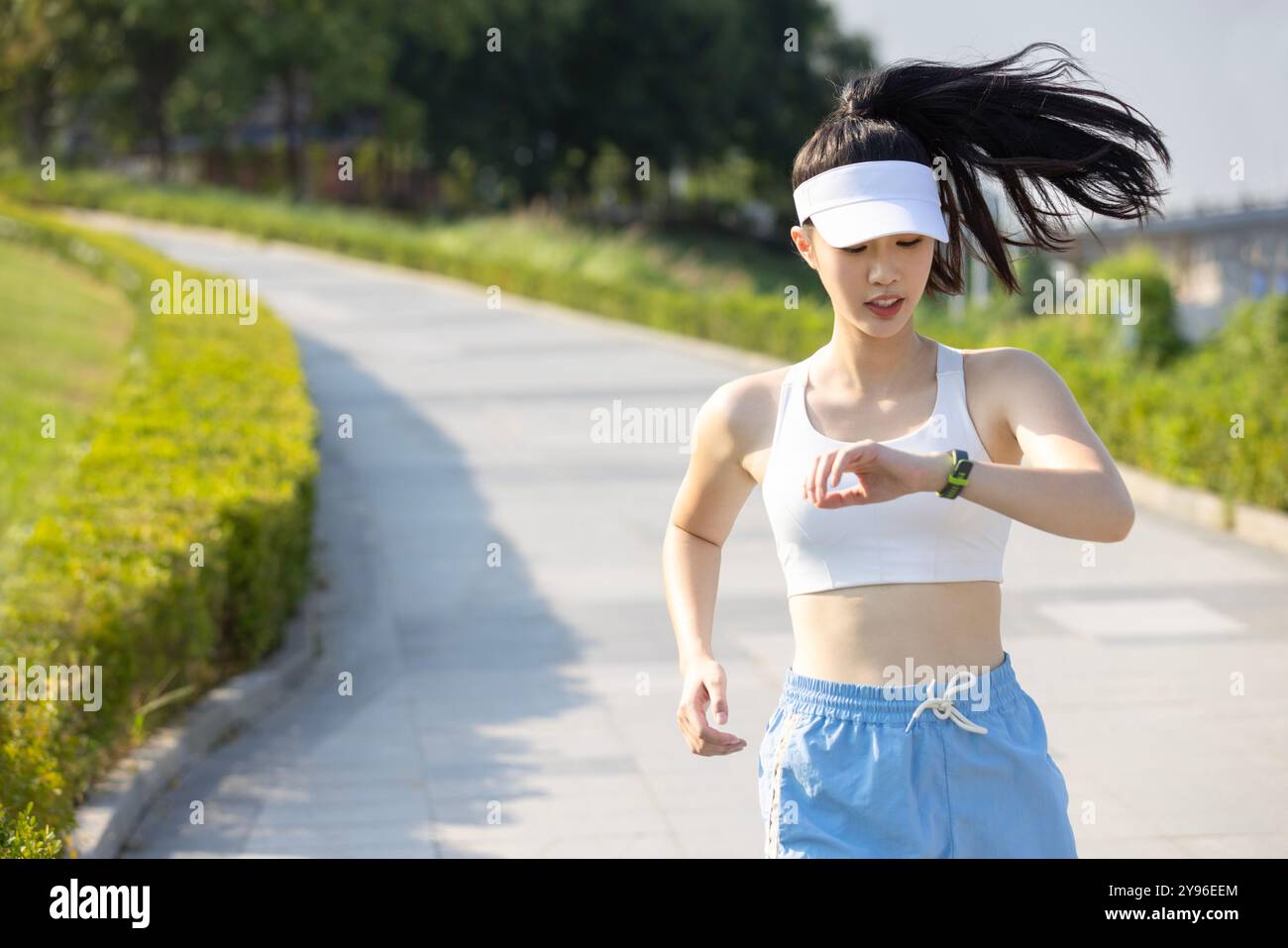 Young woman exercising in a park Stock Photo - Alamy