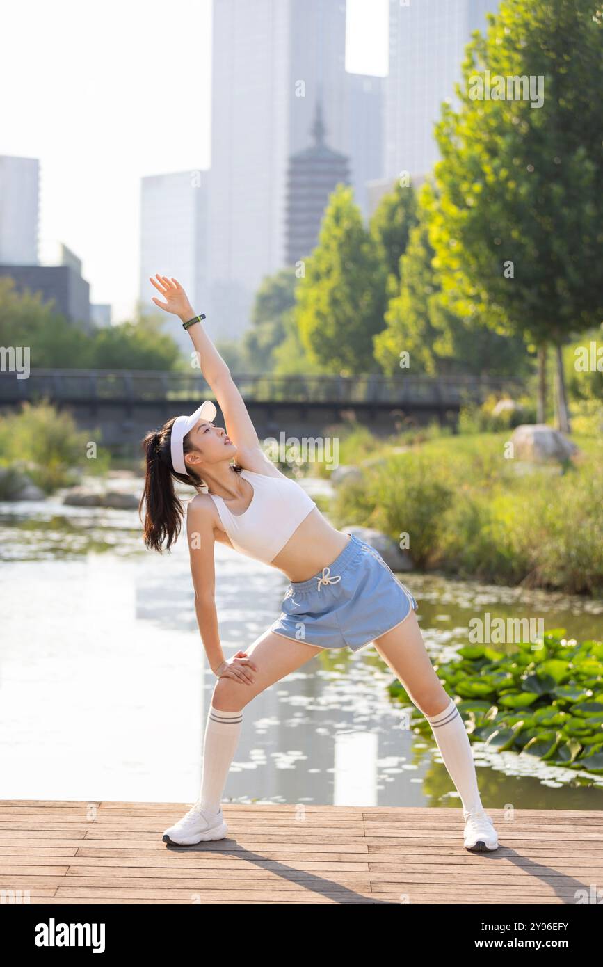 Young woman exercising in a park Stock Photo - Alamy