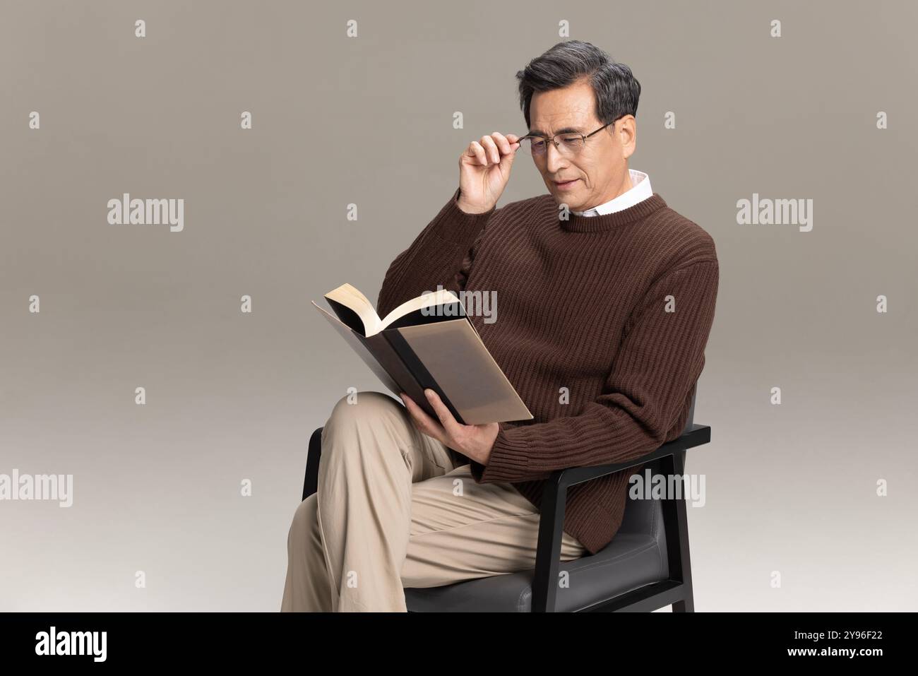 Happy senior man reading a book Stock Photo