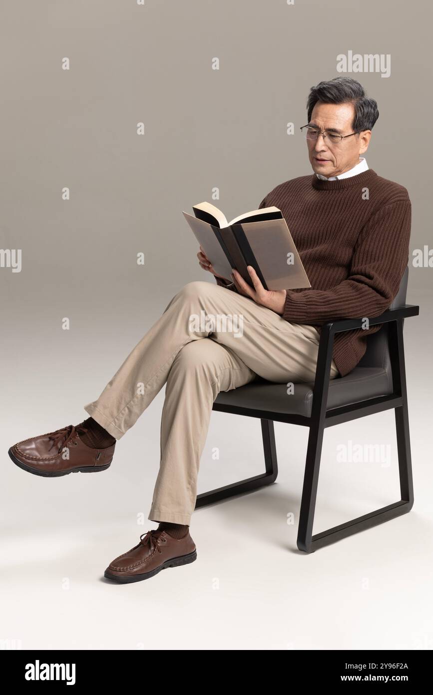 Happy senior man reading a book Stock Photo