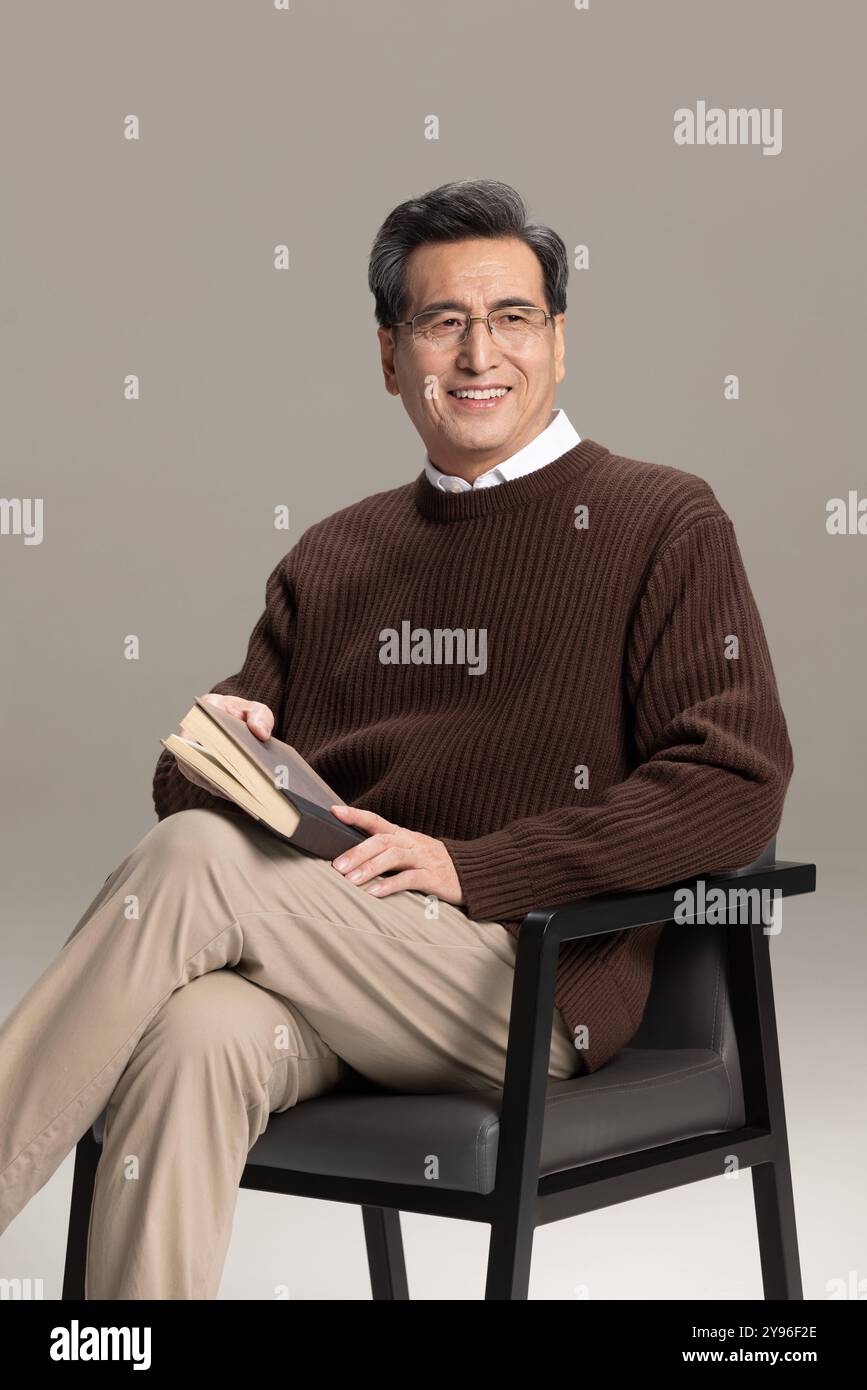 Happy senior man reading a book Stock Photo