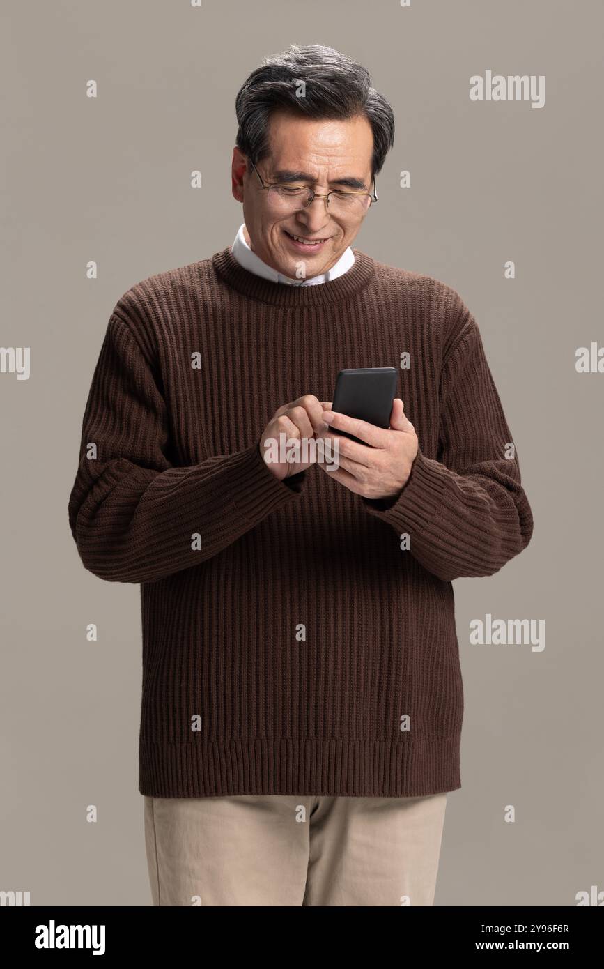 Happy senior man using smart phone Stock Photo