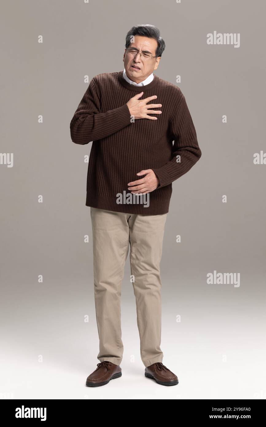 Senior man having a heart attack Stock Photo