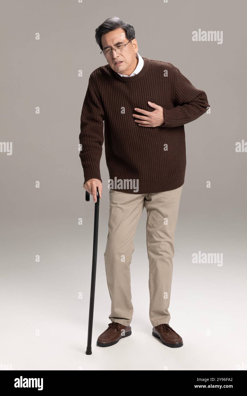 Senior man having a heart attack Stock Photo