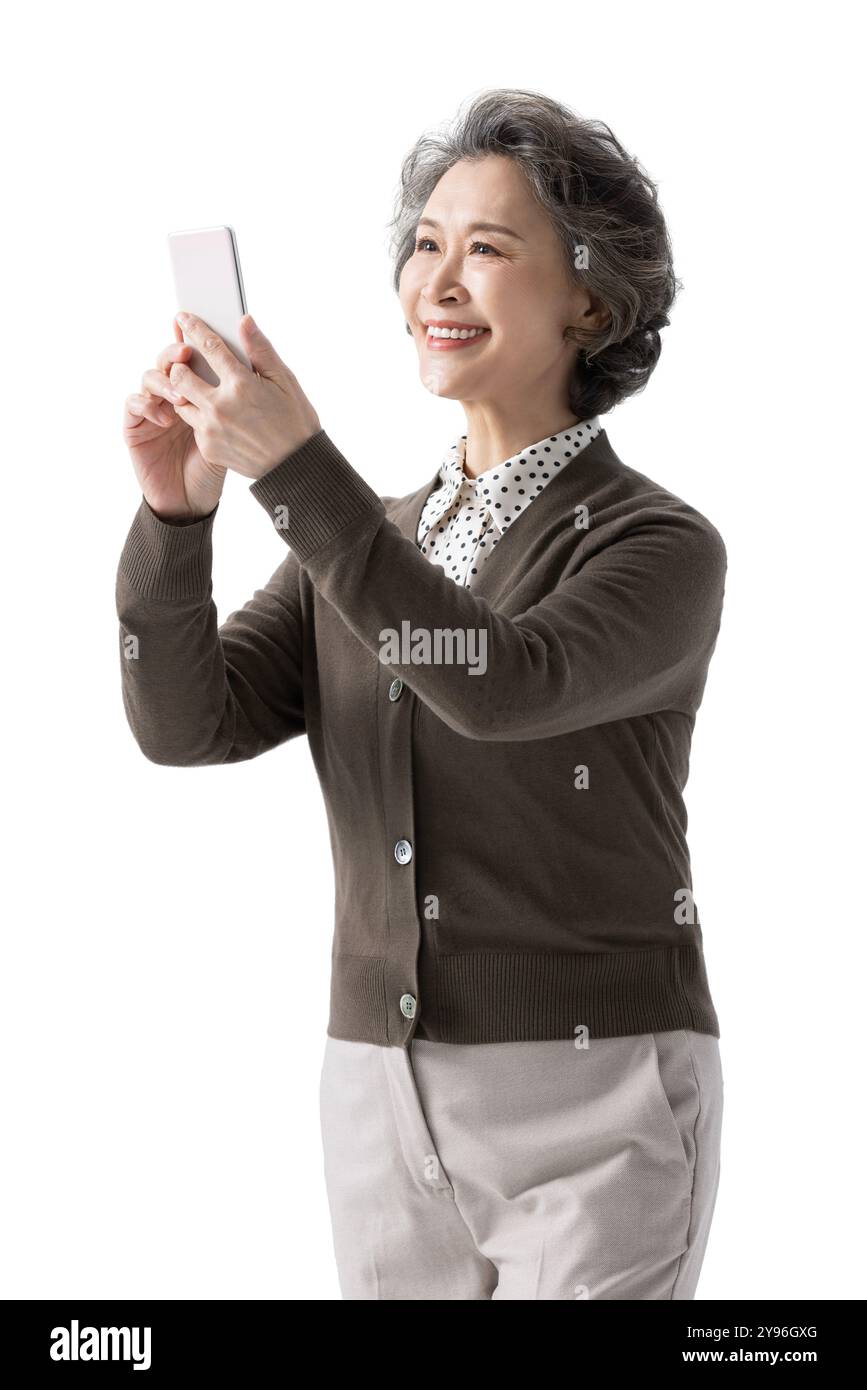Happy senior woman using smart phone Stock Photo