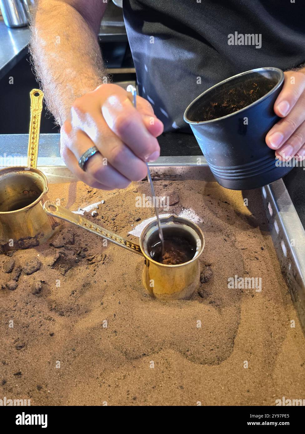 Preparing traditional coffee at Izhiman's coffee stall at the old railway station compound in Jerusalem, Israel. - Smartphone Captured Stock Image